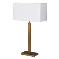Tall gilt metal lamp with rectangular white shade with a gold lining adding to the overall warm gold glow