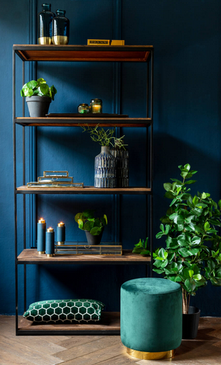 Tall shelving unit with solid mango wood shelves and a slim black metal frame in an industrial style in a living room