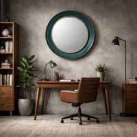 Teal round wall mirror above a desk in a home office