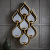 Tall teardrop-shaped mirror with pierced Moroccan-style metal frame and candleholders