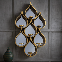 Tall teardrop-shaped mirror with pierced Moroccan-style metal frame and candleholders