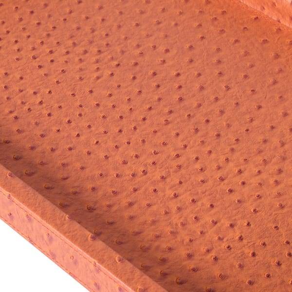 A burnt orange coloured faux leather tray with long black metal handles to each end. A particularly smart, high end look. Acessories, such as trays just add warmth and sophistication to your interior. The earthy, warm colour of this particular tray will pop in any setting.