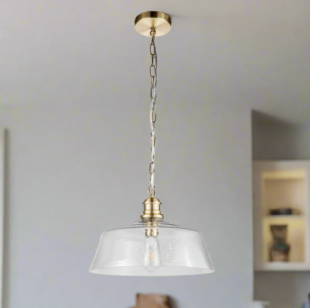 Textured glass pendant, wide shade set on a brass holder, chain and rose. The glass shade is wide enough to spread light in your kitchen, dining area or in your hall.