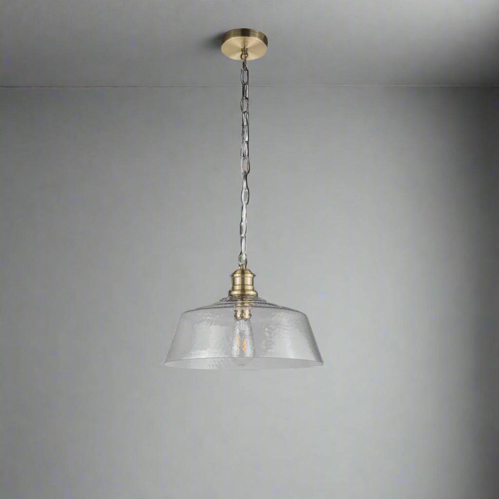 Textured glass pendant, wide shade set on a brass holder, chain and rose. The glass shade is wide enough to spread light in your kitchen, dining area or in your hall.