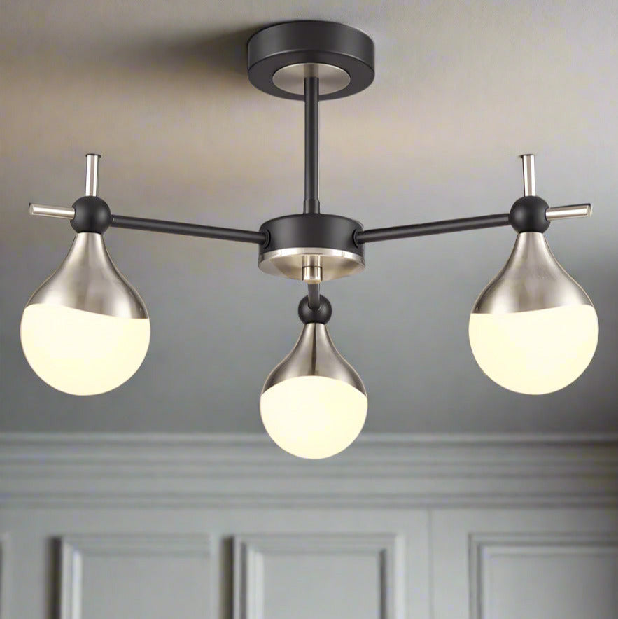 Three-light semi-flush ceiling light with opaque glass globes and nickel detailing.