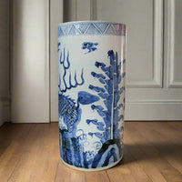 Large blue and white porcelain umbrella stand with traditional Asian dragon and floral design, cylindrical shape, glazed ceramic, decorative home storage
