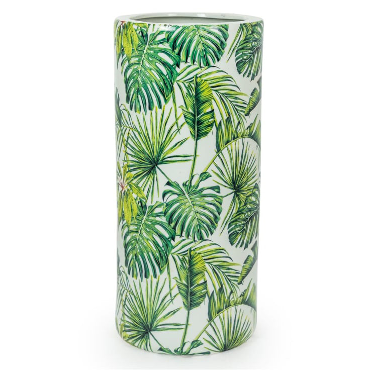 An exuberant umbrella stand with tropical leaves in a vivid green colour on a white background.