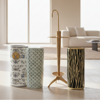 Three decorative cylindrical vases with different patterns in a living room setting.