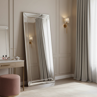 Venetian mirror hung portrait in a bedroom