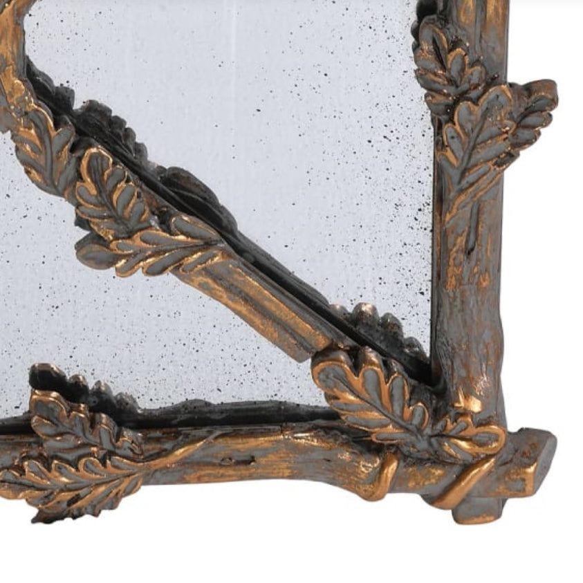 A very large matt gold gilt panel leaf mirror with a rustic verdigris finish.&nbsp; Panelled beveled glass sides reflect so much light in the vicinity of this stunning metal mirror.&nbsp; Add a touch of grandeur to any space - gorgeous. A classic vintage frame of brushed gilt foliage adds a touch of luxury to any wall.&nbsp; 