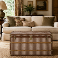Vintage striped steamer trunk storage chest as a coffee table in a living room setting