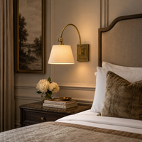 Adjustable wall light bedside a boutique style hotel bed, in a luxurious bedroom.