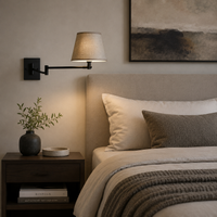 Bedside adjustable wall light over a comfortable bed in a contemporary bedroom. 
