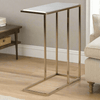 Modern side table with a white marble top and brushed gold metal legs, designed to slide under a sofa. Compact and stylish, ideal for space-saving decor.