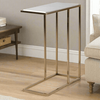Modern side table with a white marble top and brushed gold metal legs, designed to slide under a sofa. Compact and stylish, ideal for space-saving decor.