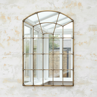 A great arched metal window mirror in an antique brass finish with studding to the frame. Like all window mirrors this one will give the impression that the room in which it hangs is larger and brighter.&nbsp; An unusual colour and the studs on the frame adding an industrial feel.&nbsp;