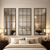Three large window mirrors across the top of a bed in a luxury, traditional style bedroom setting, each mirror reflecting from a mirror opposite, to enlarge the space and perspective.