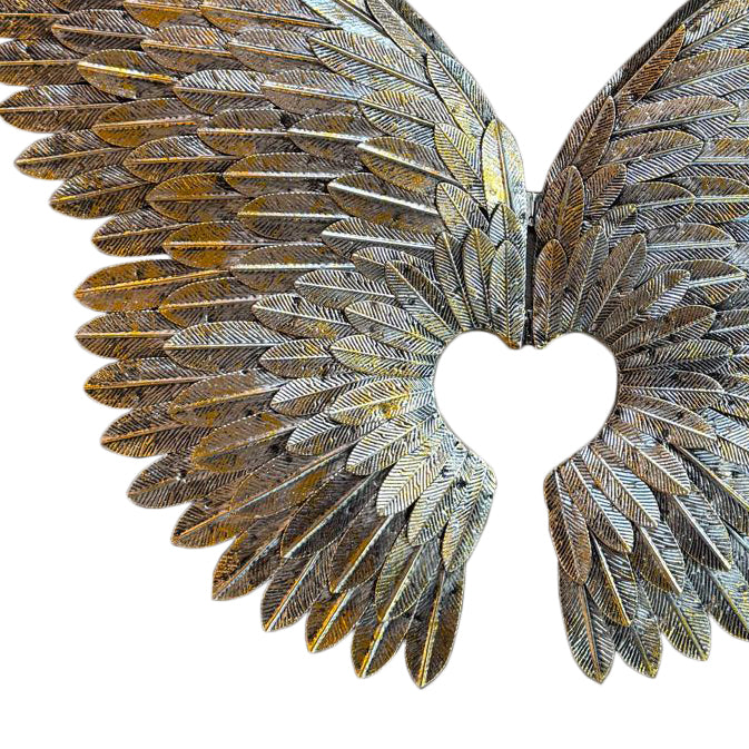 Decorative angel wings with a heart cutout on a white background