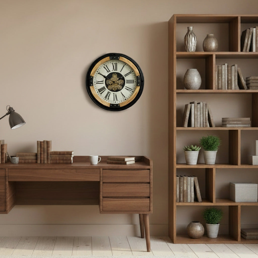 Large industrial wall clock with exposed moving gears, black metal frame, wood accents, and Roman numeral dial mounted on a dark paneled wall.