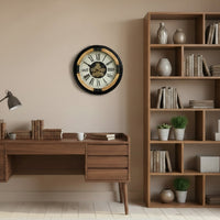 Large industrial wall clock with exposed moving gears, black metal frame, wood accents, and Roman numeral dial mounted on a dark paneled wall.