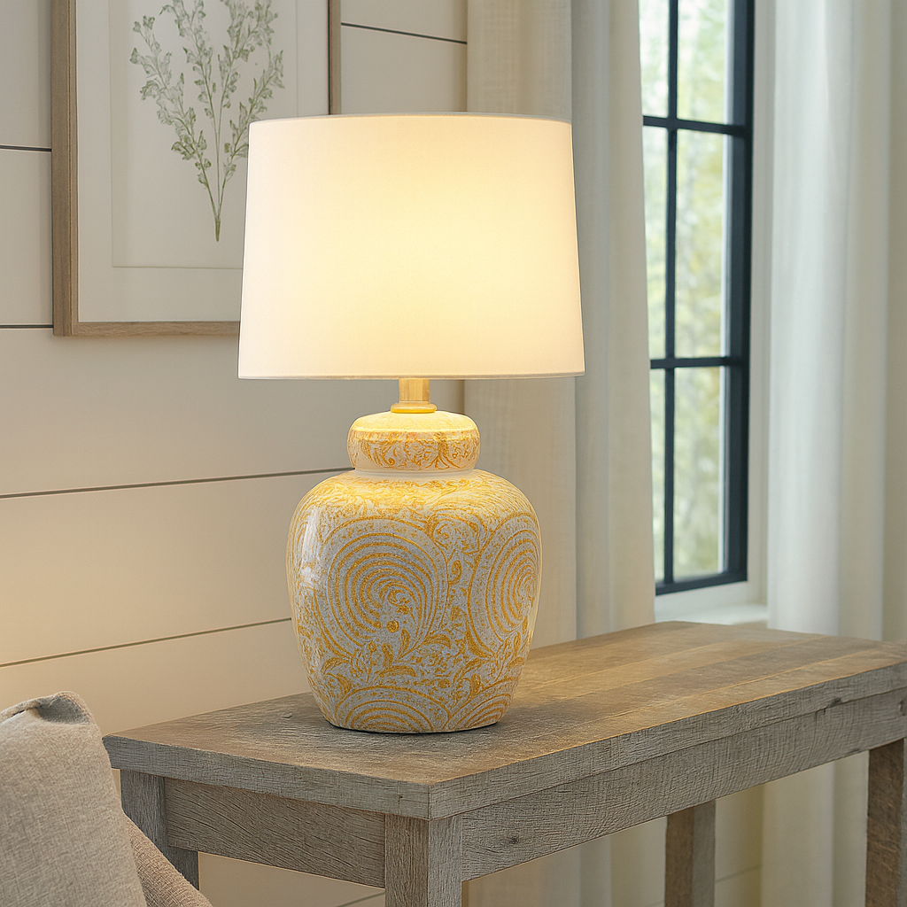 Add a pop of warmth and personality to your home with this yellow ceramic table lamp. Featuring a stunning hand-painted swirl design in sunshine yellow on a glossy white base, this lamp combines artistic charm with functional lighting. Its eye-catching pattern brings an uplifting, cheerful vibe, perfect for creating a welcoming atmosphere in your living room, bedroom, or entryway.

The classic ceramic base is paired with a neutral white lampshade, offering a timeless balance of color and texture. Whether yo