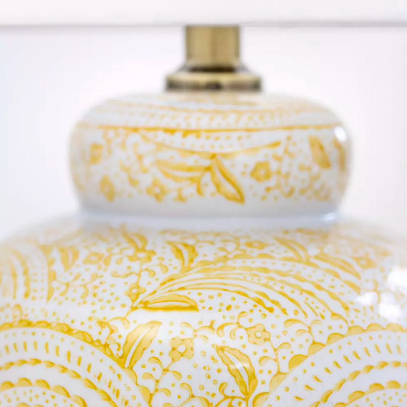 Add a pop of warmth and personality to your home with this yellow ceramic table lamp. Featuring a stunning hand-painted swirl design in sunshine yellow on a glossy white base, this lamp combines artistic charm with functional lighting. Its eye-catching pattern brings an uplifting, cheerful vibe, perfect for creating a welcoming atmosphere in your living room, bedroom, or entryway.

The classic ceramic base is paired with a neutral white lampshade, offering a timeless balance of color and texture. Whether yo