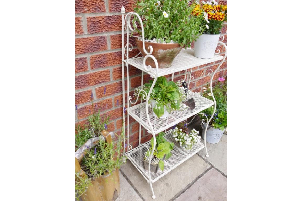 3 tier white folding shelf, great indoors or outdoors. With plants or books, this versatile little shelf can be placed anywhere, in any room, or folded neatly away when not in use.