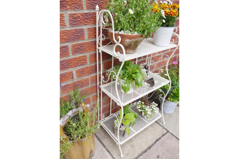 3 tier white folding shelf, great indoors or outdoors. With plants or books, this versatile little shelf can be placed anywhere, in any room, or folded neatly away when not in use.
