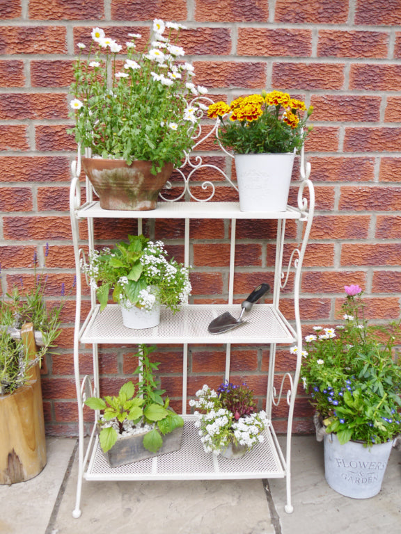 3 tier white folding shelf, great indoors or outdoors. With plants or books, this versatile little shelf can be placed anywhere, in any room, or folded neatly away when not in use.