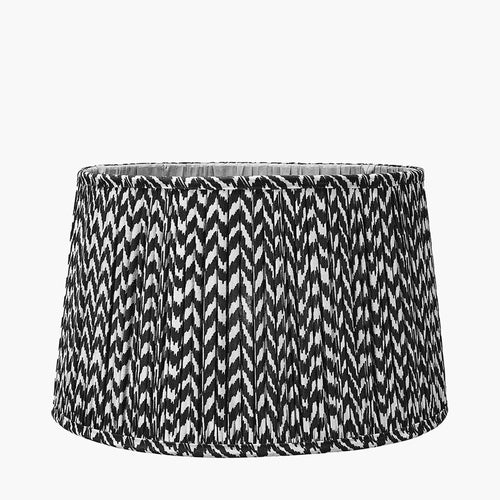 Beautifully patterned black and cream lampshade, pleated in a tapered shape.
