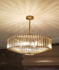 An elegant crystal and bronze chandelier with adjustable height. Its warm glow and geometric design elevate dining rooms, living rooms or hallways