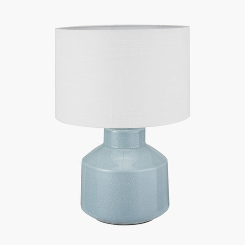 Minimalist ceramic table lamp. Exquisite crackle effect detail on this beautifully duck egg blue coloured lampbase and the white linen shade will add a 'scandi' factor to any interior.