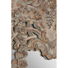 An oversized ornate mirror in a weathered, limewashed finish.