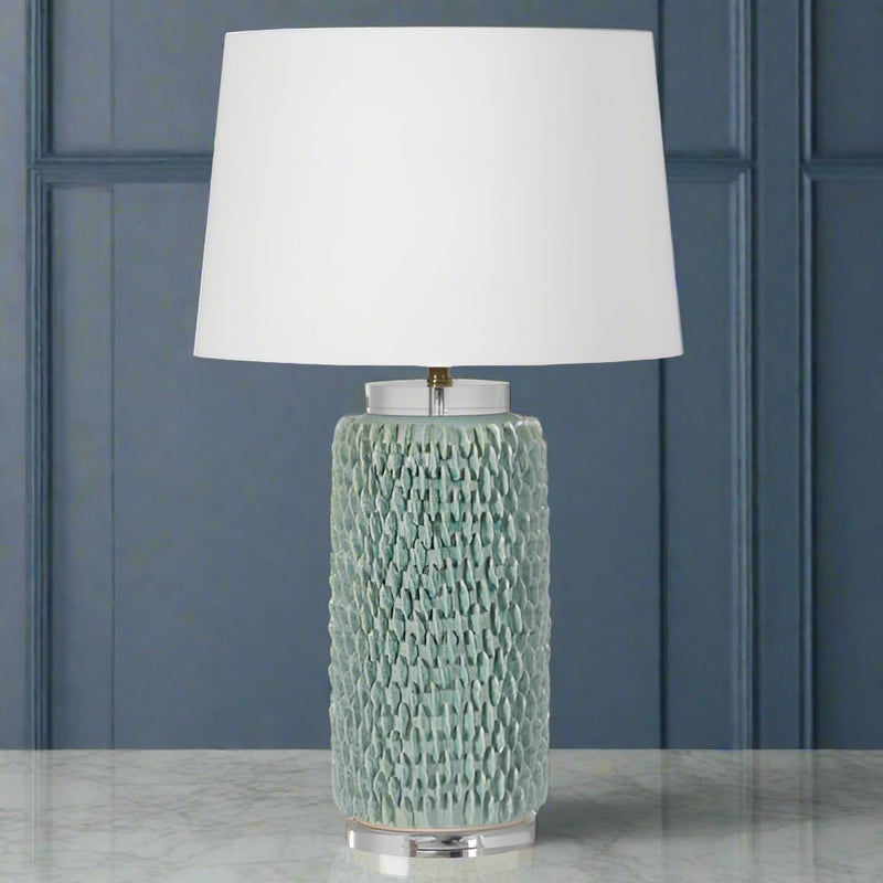 Very intricate green 'petal' embossed lamp with lucite base and top. Inclusive of white shade.