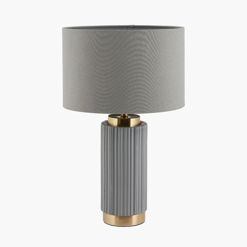 Deep grey, taupe coloured ribbed ceramic base on a gilt base with a linen style same colour shade. A smaller lamp with with a huge impact a great iconic look.  H: 45 cm  W: 28 cm