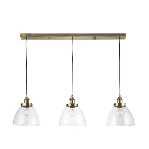 3 light, linear pendant in clear glass with antique brass metal accents and ceiling plate. To add light over your kitchen island or dining area.