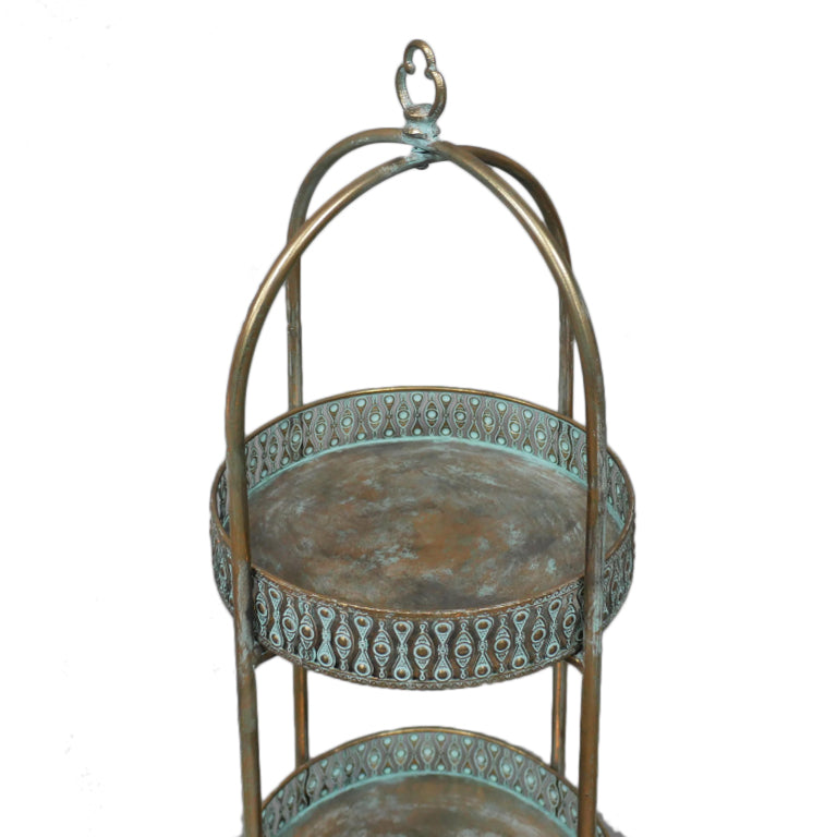 A unique and very pretty shelf unit with pierced metal detailing around shelves that can be lifted out and also used as trays. Finished in a rustic antique gold, this furniture piece has Moroccan vibes with five shelves encased in an outer frame that can fold flat.