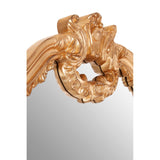 Gold ornate mirror with classic shape and baroque frame.