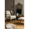 Exceptionally large and decorative scroll mirror in a limewashed ornate frame.