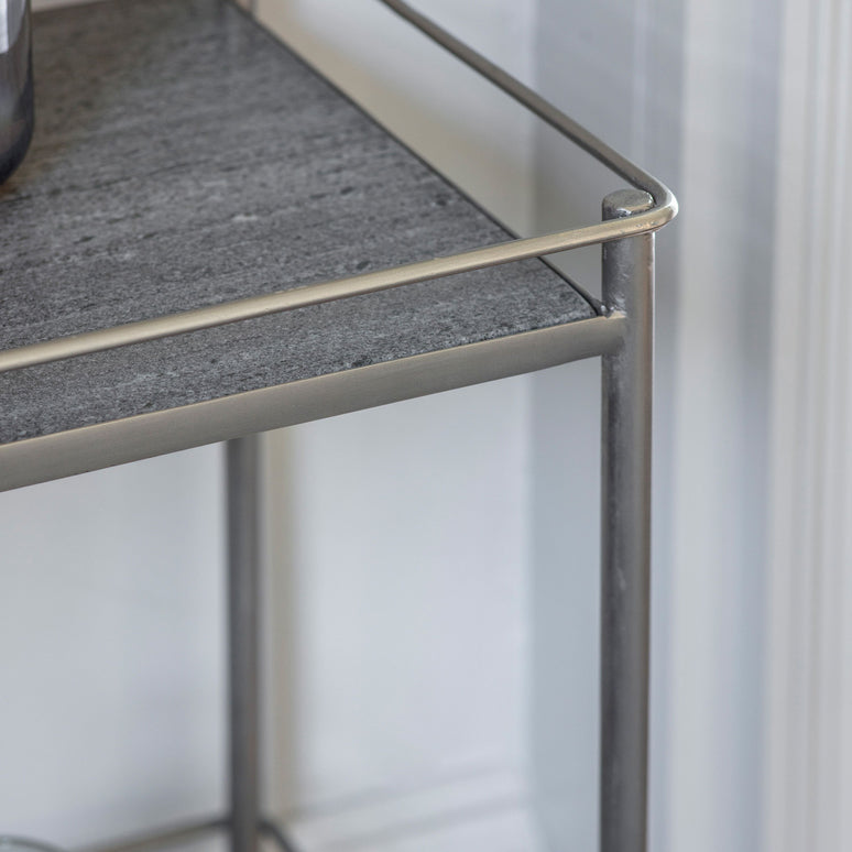 A side table with a marble top and a shelf in a soft champagne metal finish. A luxurious addition for any room.