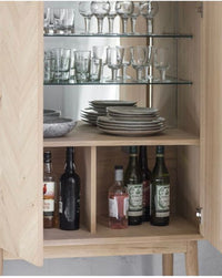 Tall natural oak veneered cocktail cabinet with 2 internal glass shelves and internal mirrored back.