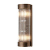 Wall light in antique brass finish with glass rods, clean simple finish.