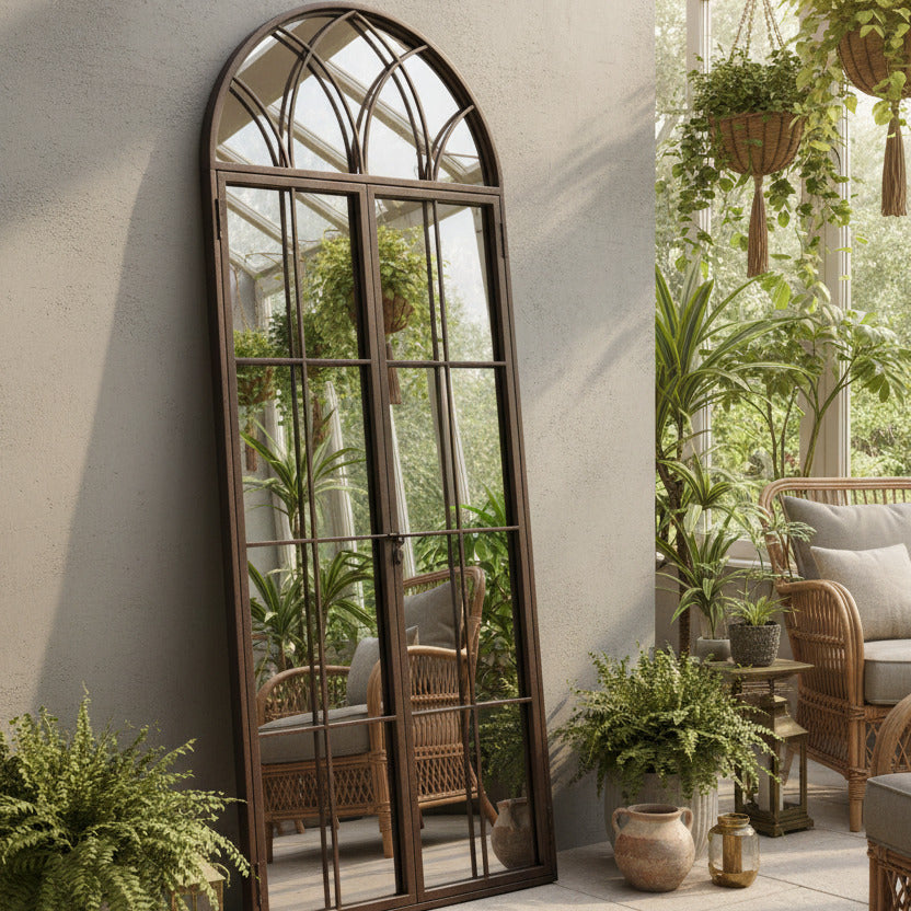 Window mirror in an antiqued bronze finish, traditional arched shape and opening latch door giving an even deeper perspective to any wall.
