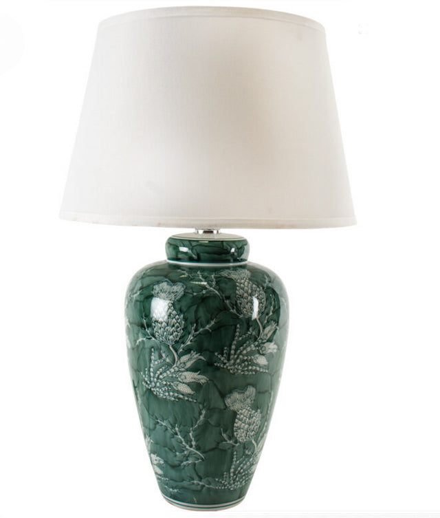 &nbsp;An unusual take on the classic blue and white, this stunning thistle patterned green and white lamp is so perfect with a large white shade. A particularly stunning colour a really vibrant green showing the thistle pattern,&nbsp; When illuminated through the pale coloured linen shade the light from the lamp will enhace the light in any room. Perfect on a console table behind a sofa or a hll. Check our website for a range of large ceramic lamps and shades.


H: 70 cm W: 43 cm 