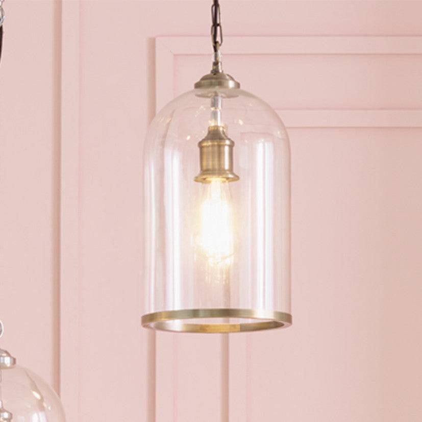 A glass pendant with Brass or Nickel rim at the Base and same colour ceiling rose. Perfect hall light, seen here hanging in a pink paneled room.