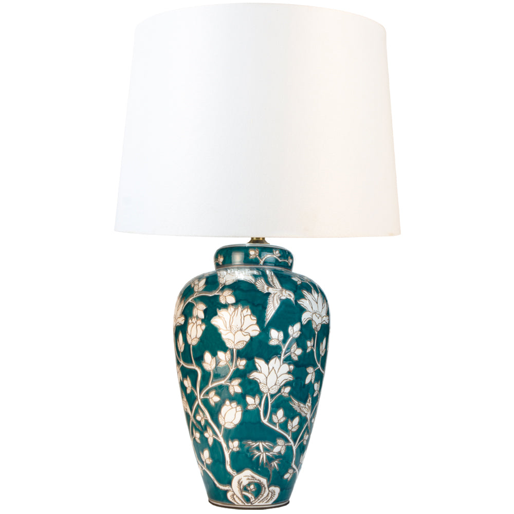 Tall green and white floral swirl ceramic base table lamp with white shade. Stunning floral green and white lamp with large ivory coloured white shade. Ceramic lamps are a staple of English country house decor but usually in a blue and white colour, this is different take on the theme in a striking deep green and white. You can find a wide range of these classic ceramic lamps and shades on our website, in many colours and sizes.&nbsp;